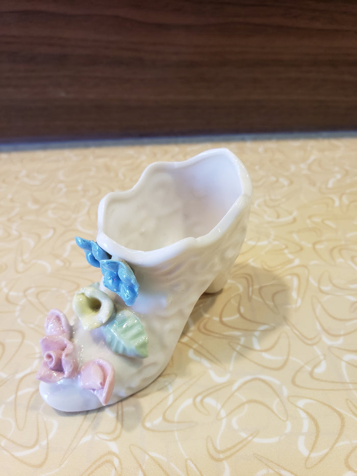 Delicate white porcelain shoe with flowers