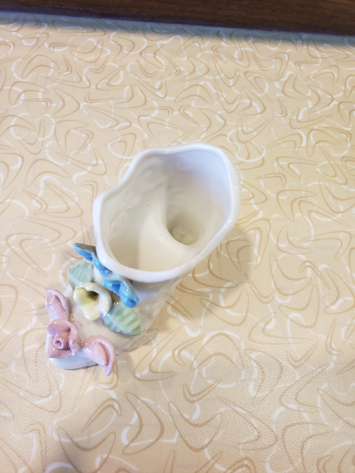 Delicate white porcelain shoe with flowers