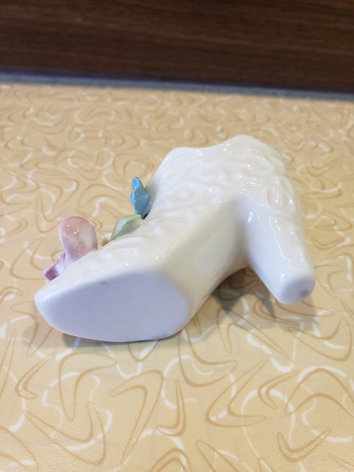 Delicate white porcelain shoe with flowers