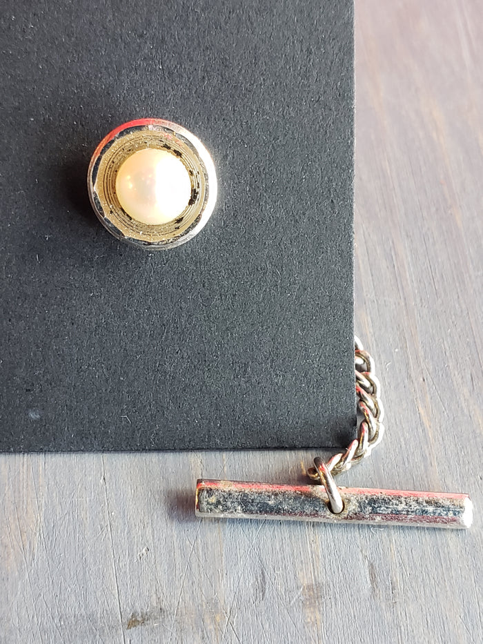 White bead in elegant silver setting tie tack